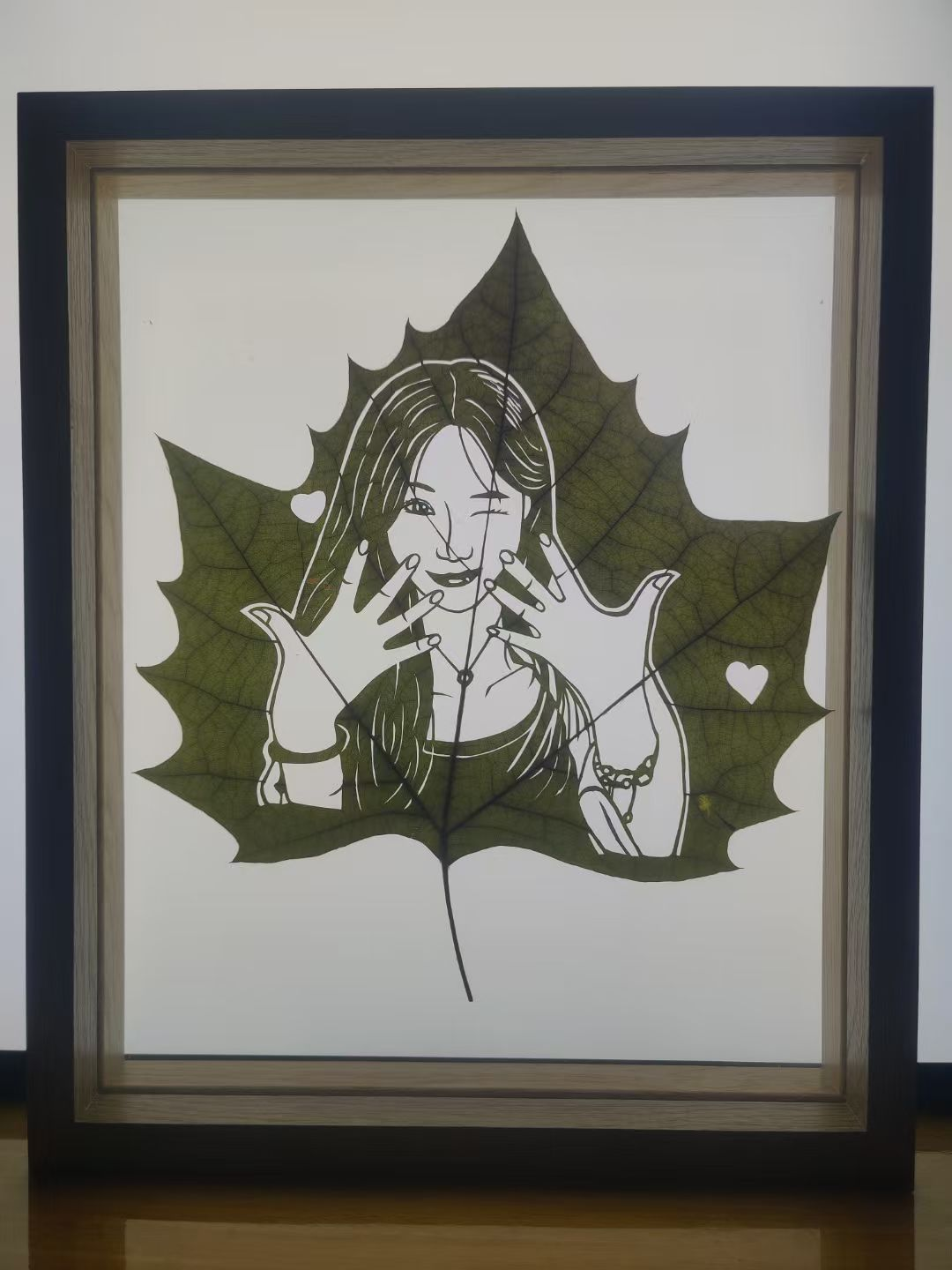 Custom Portrait Leaf Carving – Playful Heart Pose Framed Art